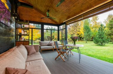 Elegant modern porch with comfortable seating and vibrant garden view.